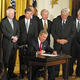 As supporters look on, Bush signs the Bill Of Rights Reduction And Consolidation Act.